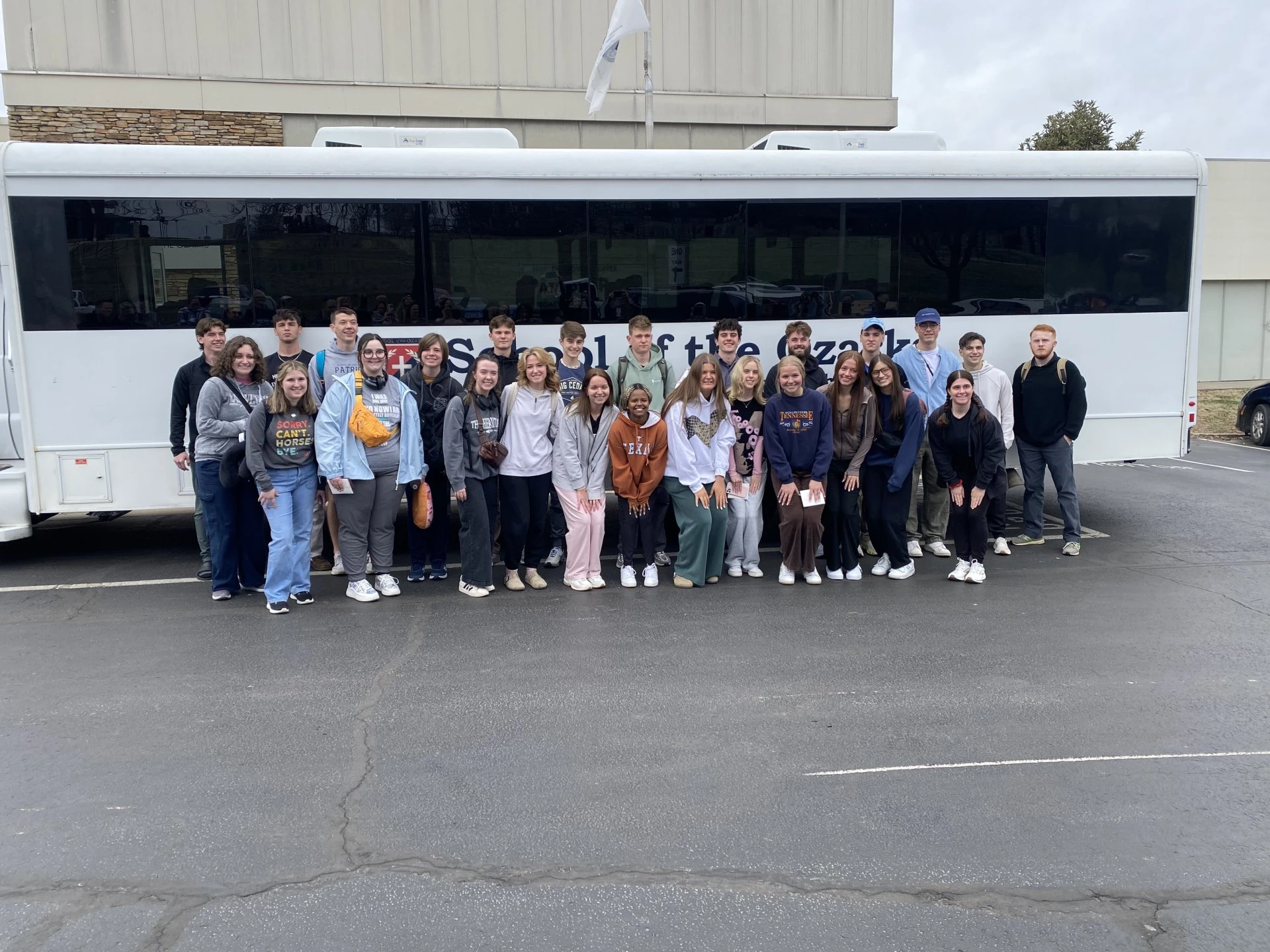 a group of people standing in front of a bus