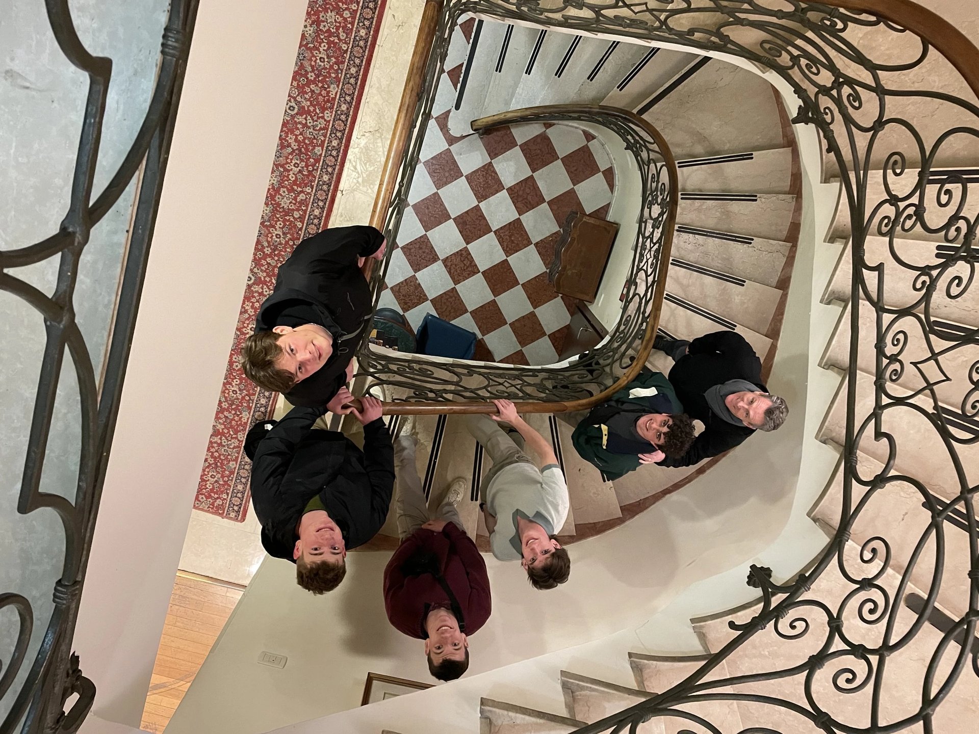 a group of people standing around a staircase