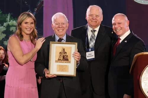 People posing with award