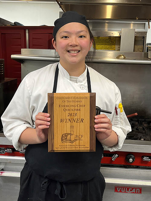 girl holding a plaque