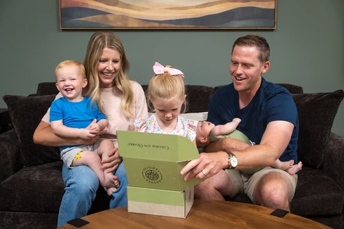 Family opening their Rooted Families Kit
