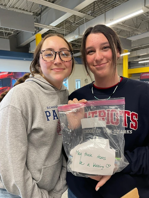 School of the Ozarks students write encouraging notes to the people who receive the kits. 