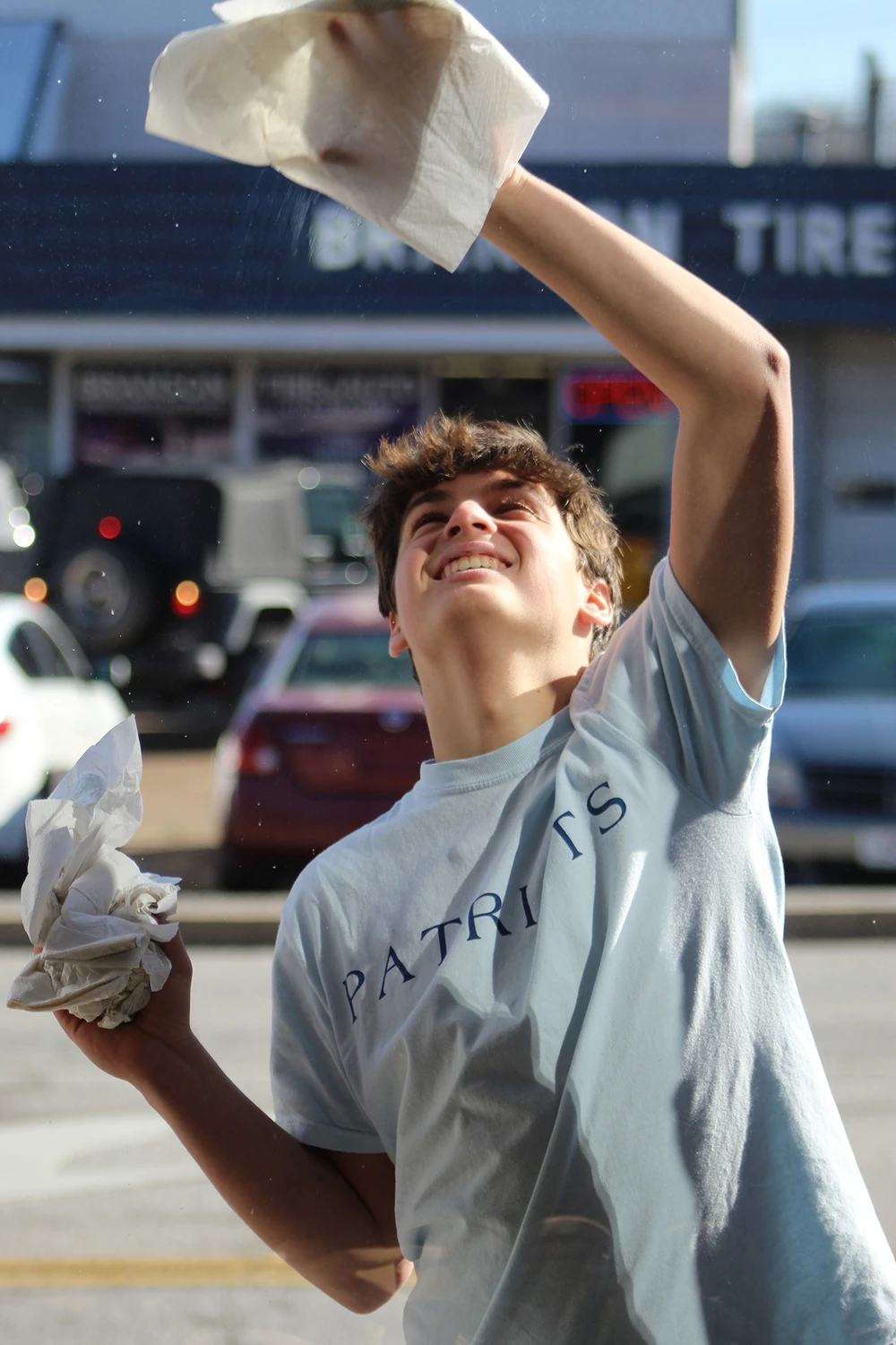 Boy washing windows.