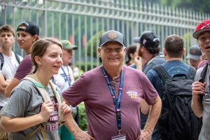 Veteran standing with student