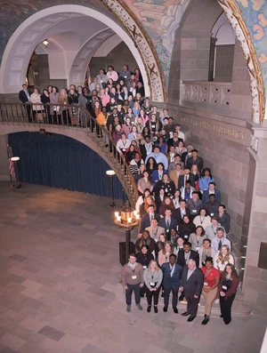 Young people line up in staircase with Governor Mike Parson in the capitol building. 