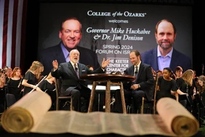 Mike Huckabee and Jim Denison on stage