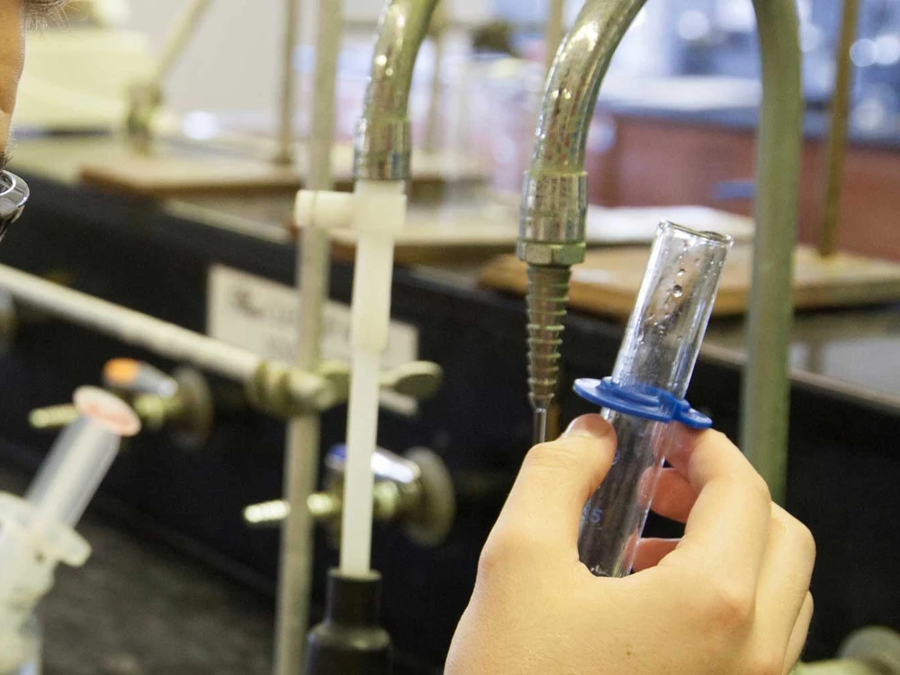 student looking at chemistry tube
