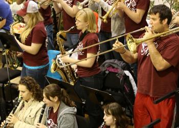 Pep band performing at a ball game