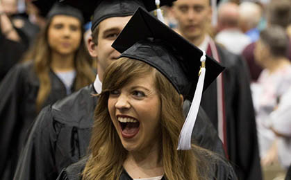 Student smiling at graduation.