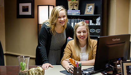 Student and supervisor at desk