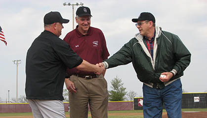 Alumni visiting and shaking hands.