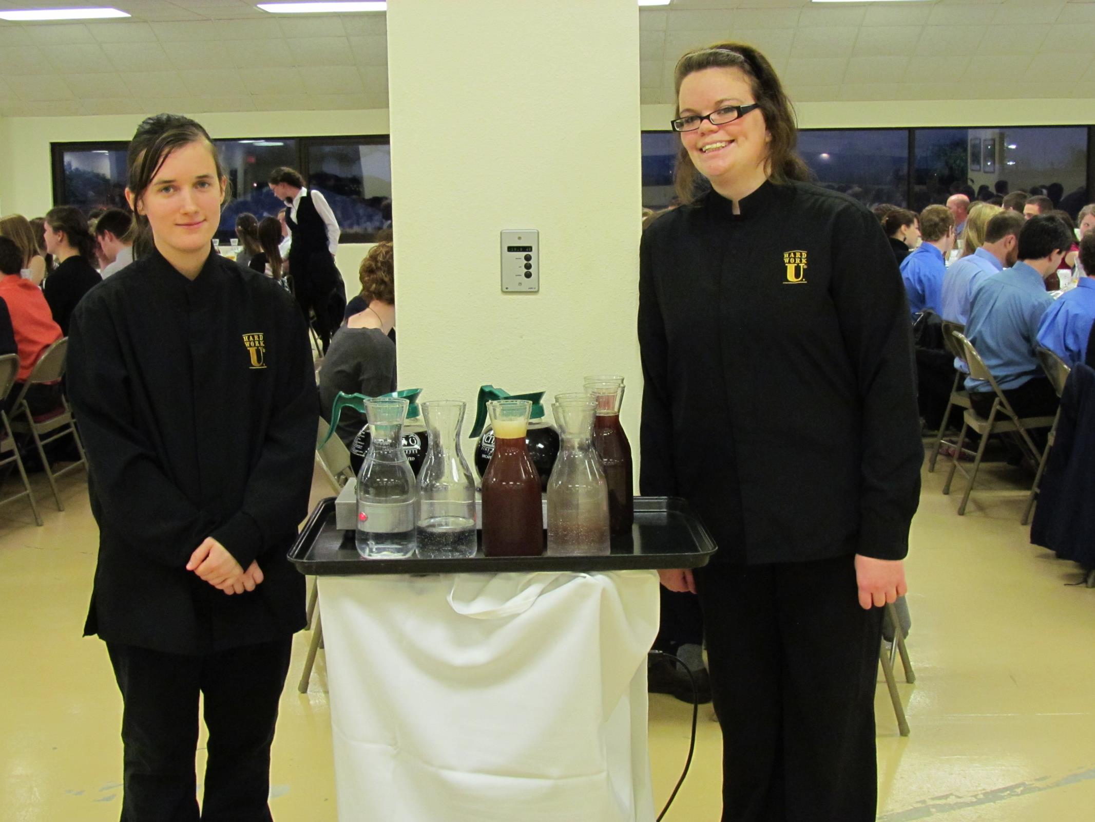 Students serving food for guests