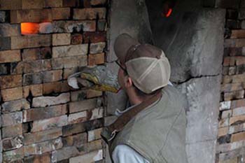 Instructor checks the temperature of the kilns