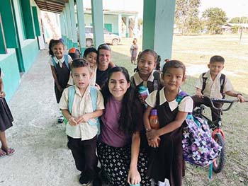 C of O student with children in Belize