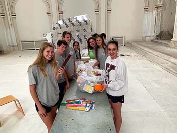 Student at table organizing art supplies