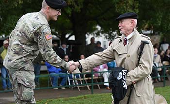 Col. John Clark greets cadet