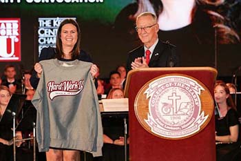 Sarah Huckabee Sanders holds Hard Work U. sweatshirt presented by Dr. Davis