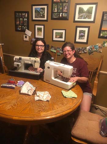Nancy Webb, a preschooler from Kirbyville School District, is delighted to receive meal items from the school. They provide meals for all their students three times a week. Craig Ernsting, director of food service at the Pearl Rogers Dining Center at College of the Ozarks, gave a donation of surplus food items to the Kirbyville School District.