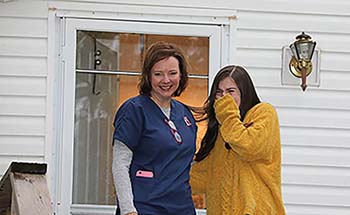 Senior Kara Bergeron, with mom Holly Bergeron by her side, is honored and overwhelmed with emotion by the procession yesterday.