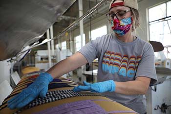 Residence Director Jana Goodwin presses masks in the C of O laundry.