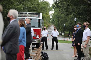 Nathan Bailey, senior fire science major, rings the symbolic volley of the bell broadcasted across campus. 