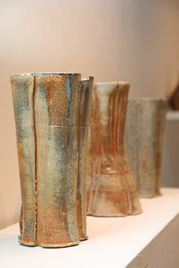 A variety of tall earth-tone ceramic vases