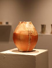 Bright orange tulip-shaped ceramic vase.