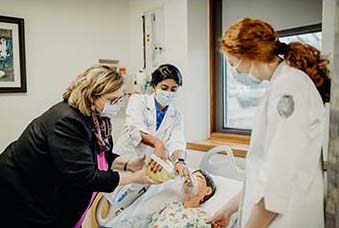 Janice Williams, instructs students during a simulation lab at the Armstrong McDonald Clinic on the C of O Campus. 