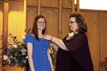 College of the Ozarks student receives nursing pin during the 2019 Pinning and Blessing Ceremony from Dr. Janice Williams, nursing program director. 