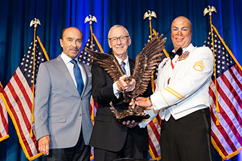 Lee Greenwood and SSG Shilo Harris present the Lee Greenwood Patriot Award to Dr. Jerry C. Davis.