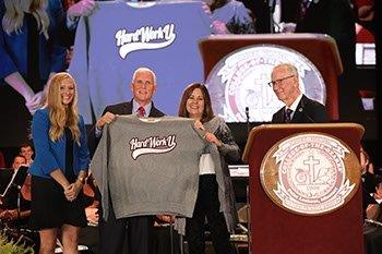 Graphic design major Allison Middleton presents college gifts to Pence and his wife Karen Pence. (Photo by Shann Swift)