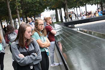 Reflections at the 9/11 Memorial Pools are somber, as senior elementary education major Alexis Rhodes (left) and senior nutrition and dietetics major Noelle Zeller (right) contemplate the attack which took place on American soil.