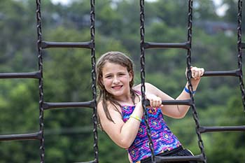 Camper Emmie Wilks enjoys playing on the Camp Lookout playground. After two years of COVID precautions, Camp Lookout returned for a 28th year of summer camp.