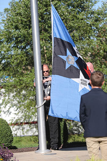The 9/11 National Remembrance Flag is raised by College of the Ozarks Director of Public Safety and U.S. Marine Corps Veteran David Kempf.